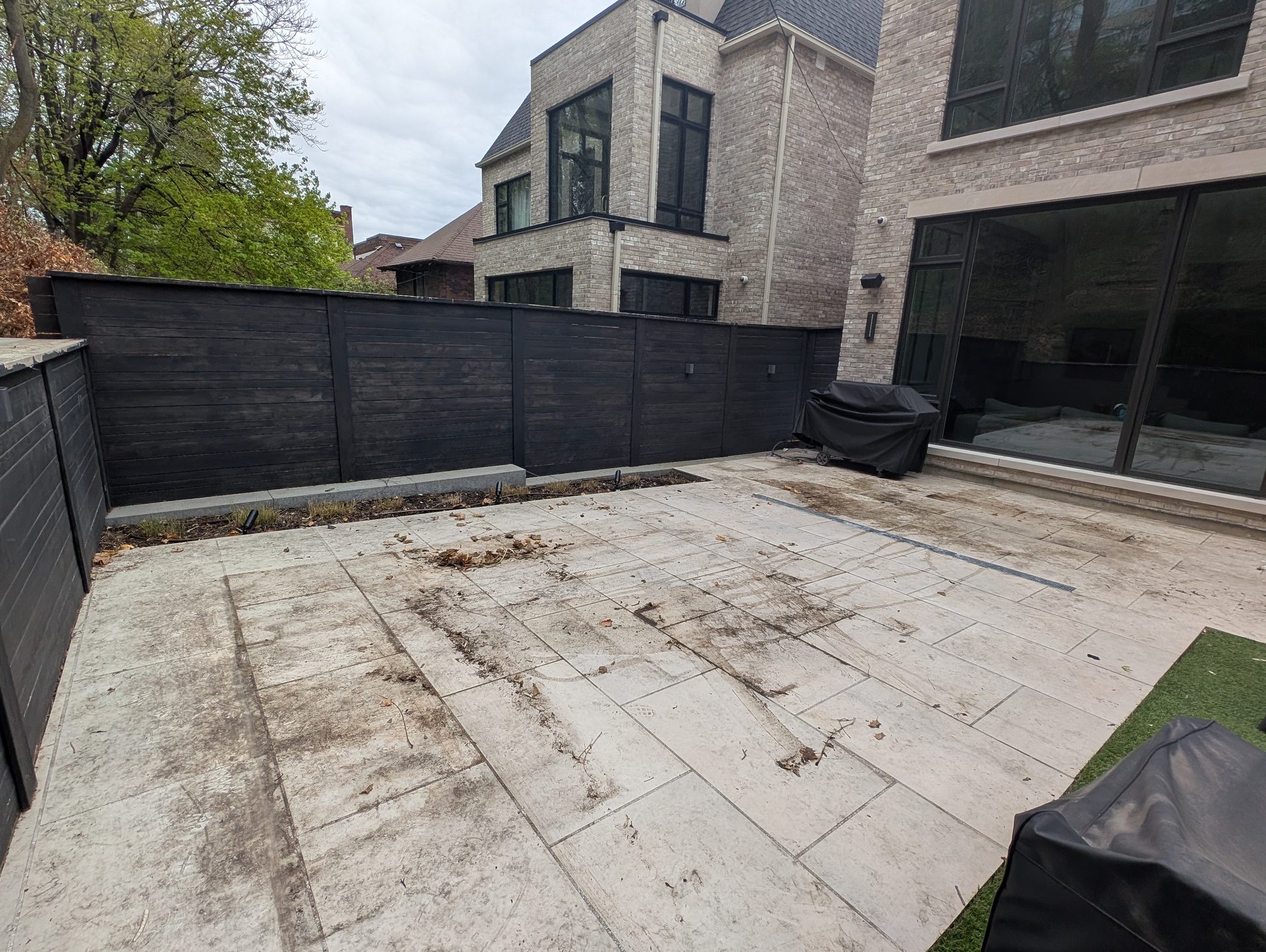 Before: Removing winter salt, dirt, leaf tannin stains from a stone patio in South Hill during our professional cleaning treatment