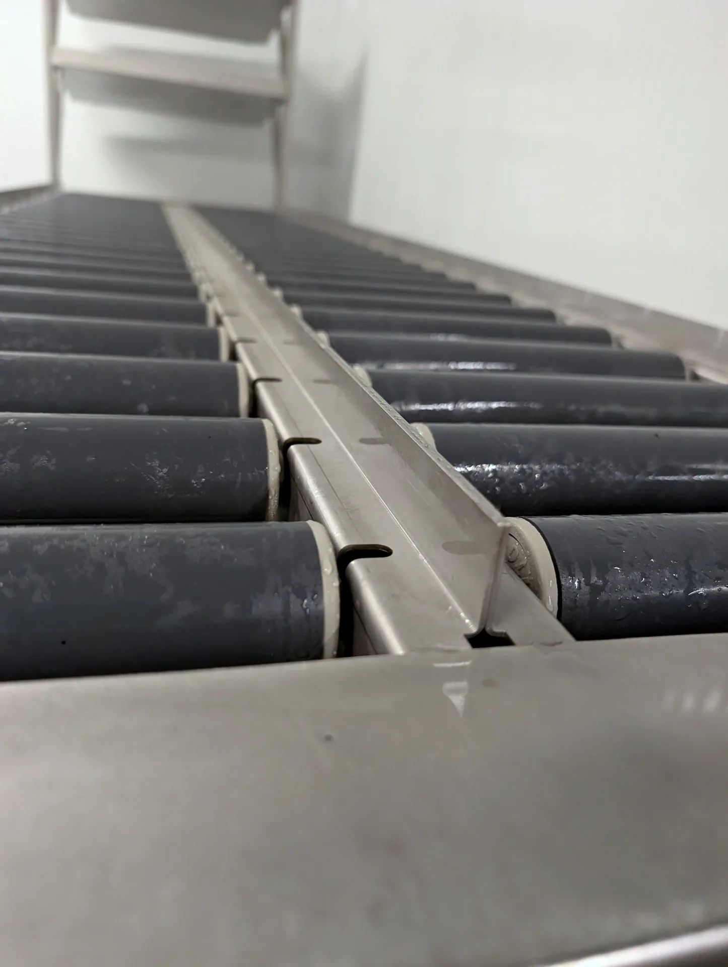 Sanitized dairy cooler gravity rollers deep cleaned by Ace Power Washing for food safety compliance