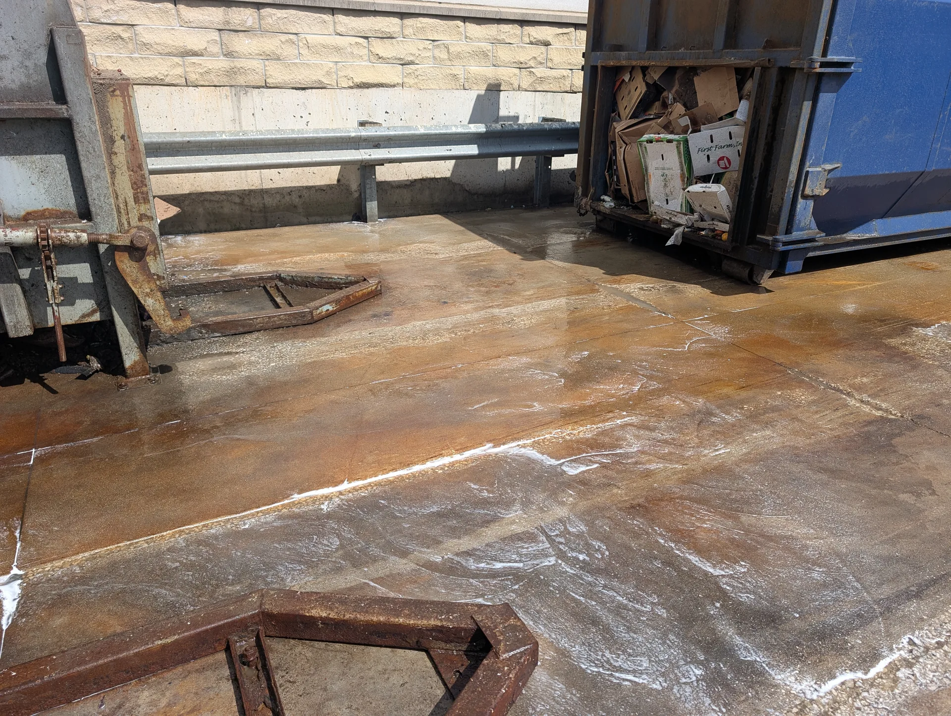 Industrial loading dock and compactor pad degreasing by Ace Power Washing to remove heavy oil and rust