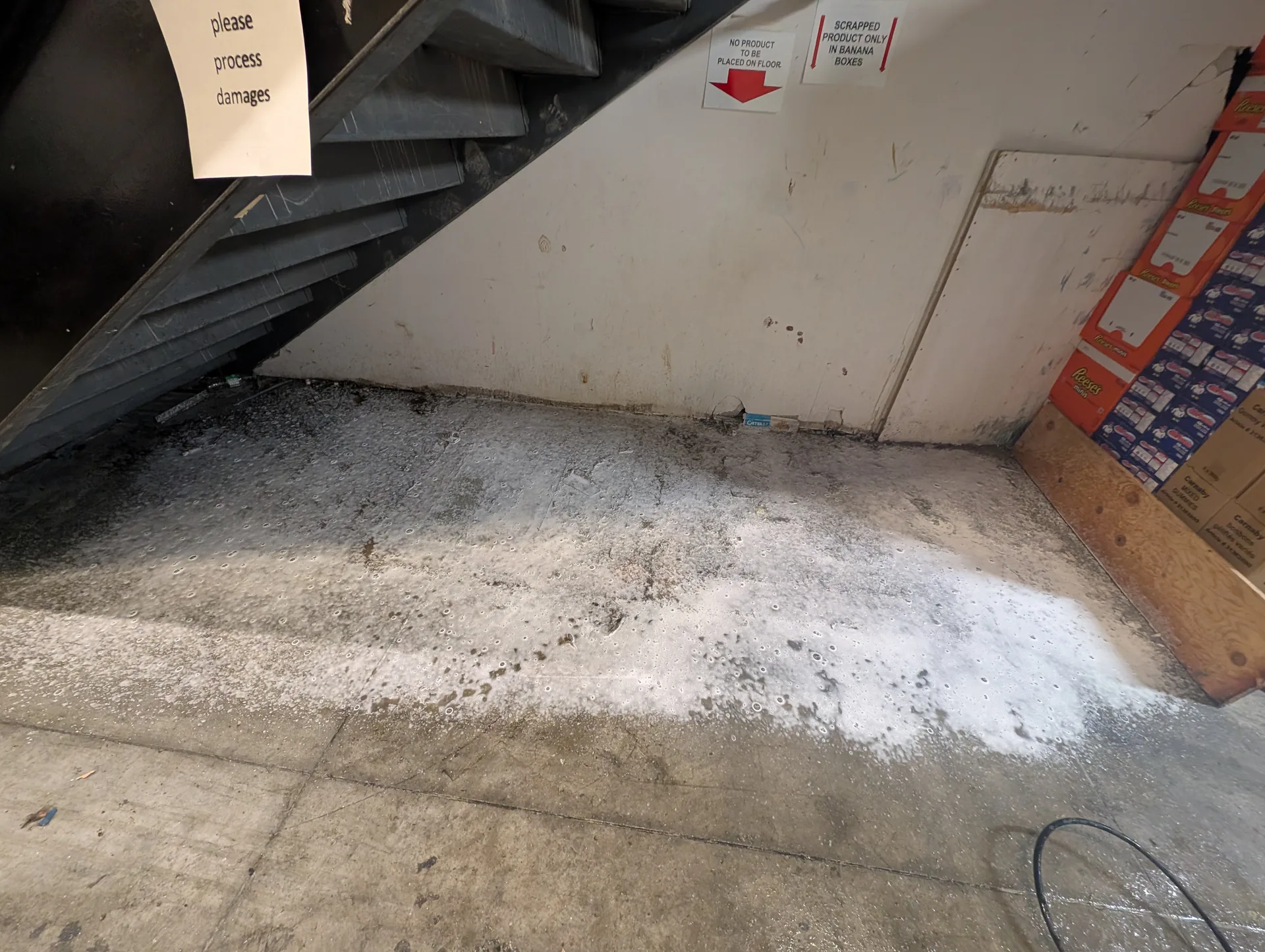 Ace Power Washing applying high-active foam degreaser to break down stubborn warehouse floor stains