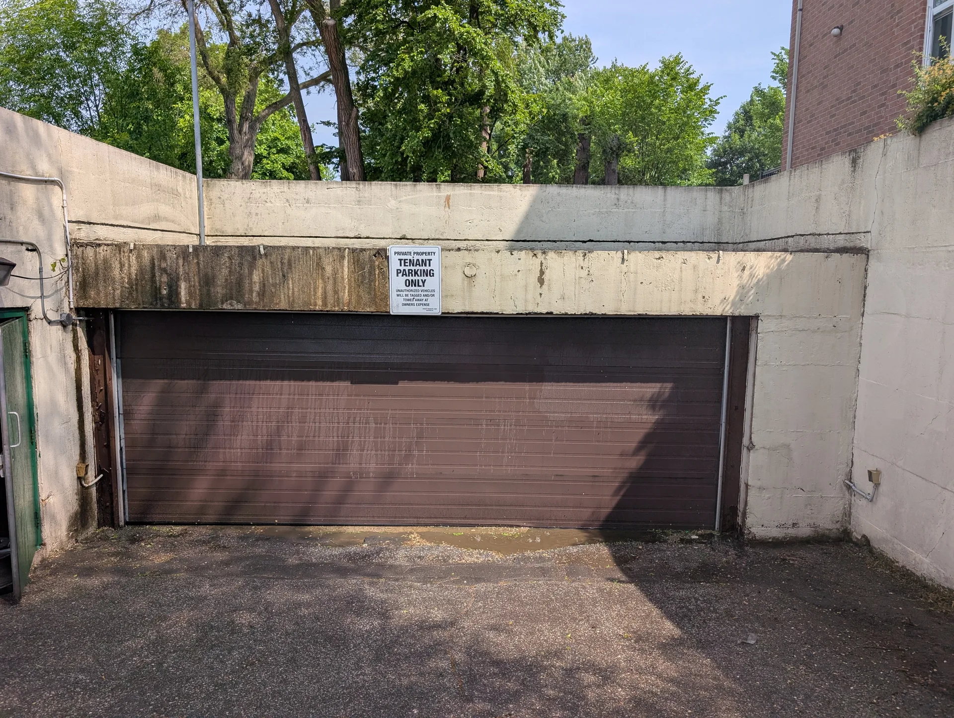 Ace Power Washing: Before photo of a tenant parking entrance with heavy algae and concrete staining