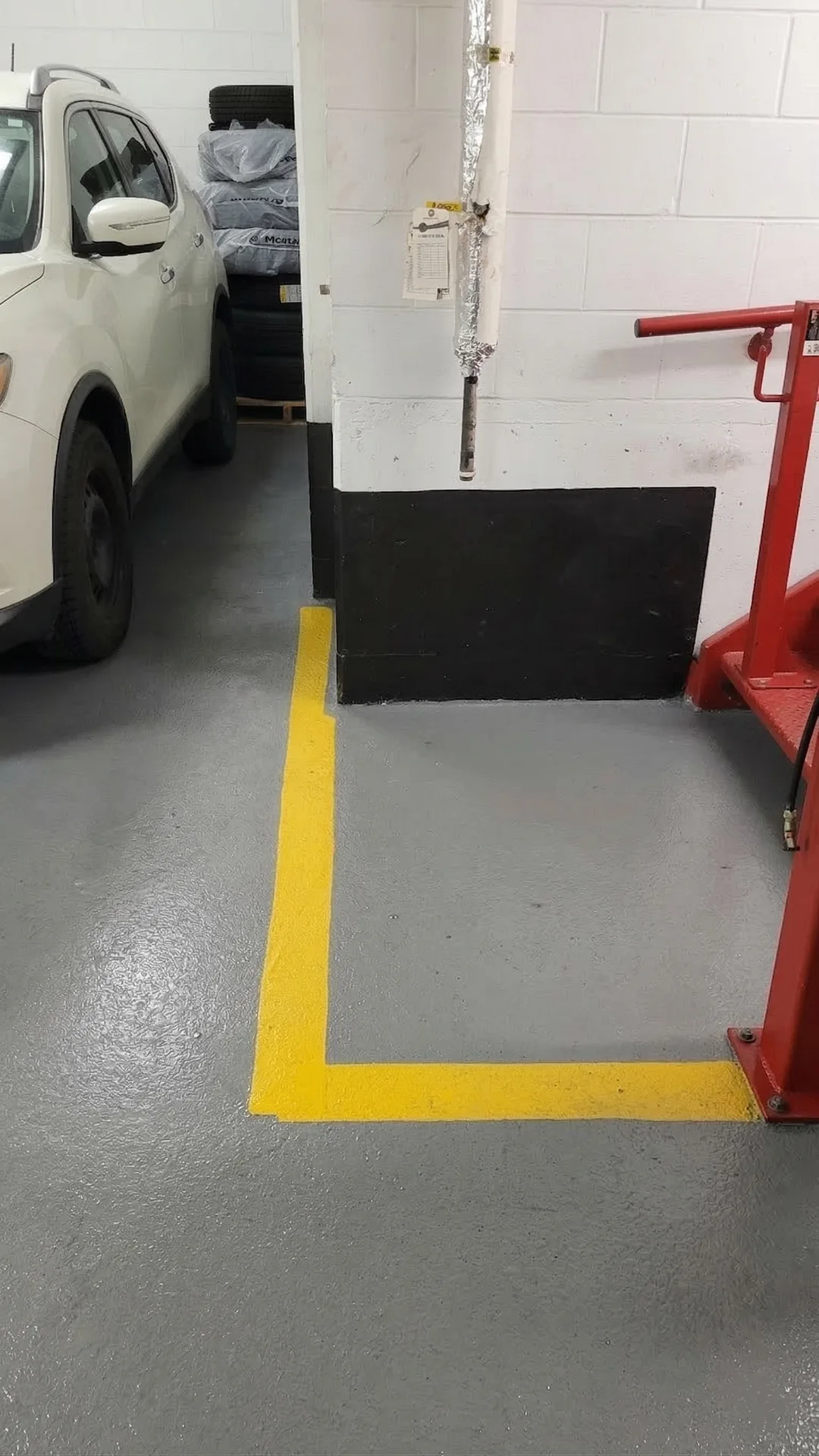 Professionally cleaned epoxy garage floor with bright safety lines, ready for commercial operations