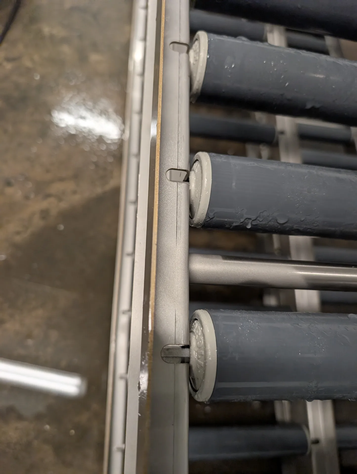 Clean and sanitized gravity feed rollers for a commercial dairy display after a deep pressure wash