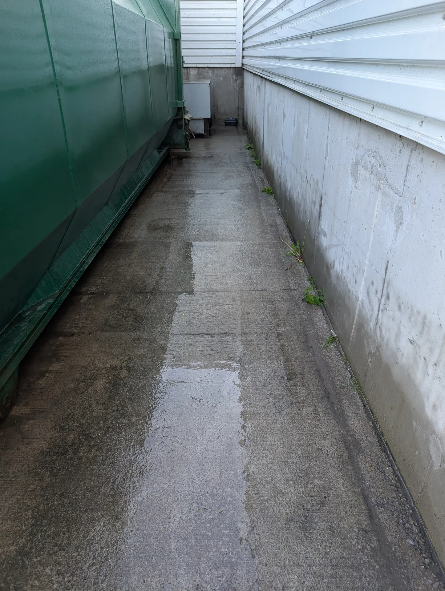 Professional concrete cleaning by Ace Power Washing for industrial walkways and waste management areas