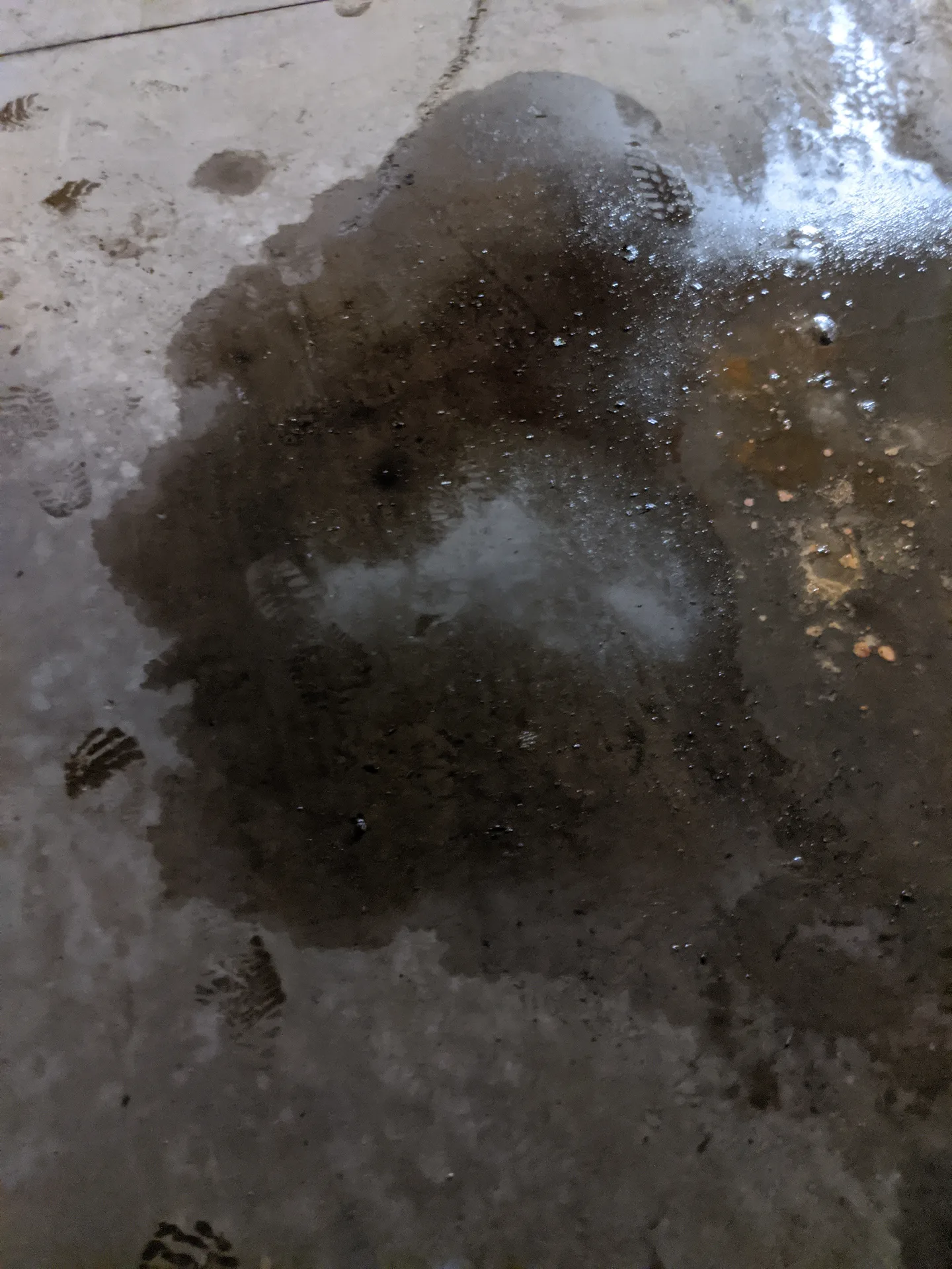 Ace Power Washing applying a industrial detergent degreaser to a heavy engine oil stain on concrete