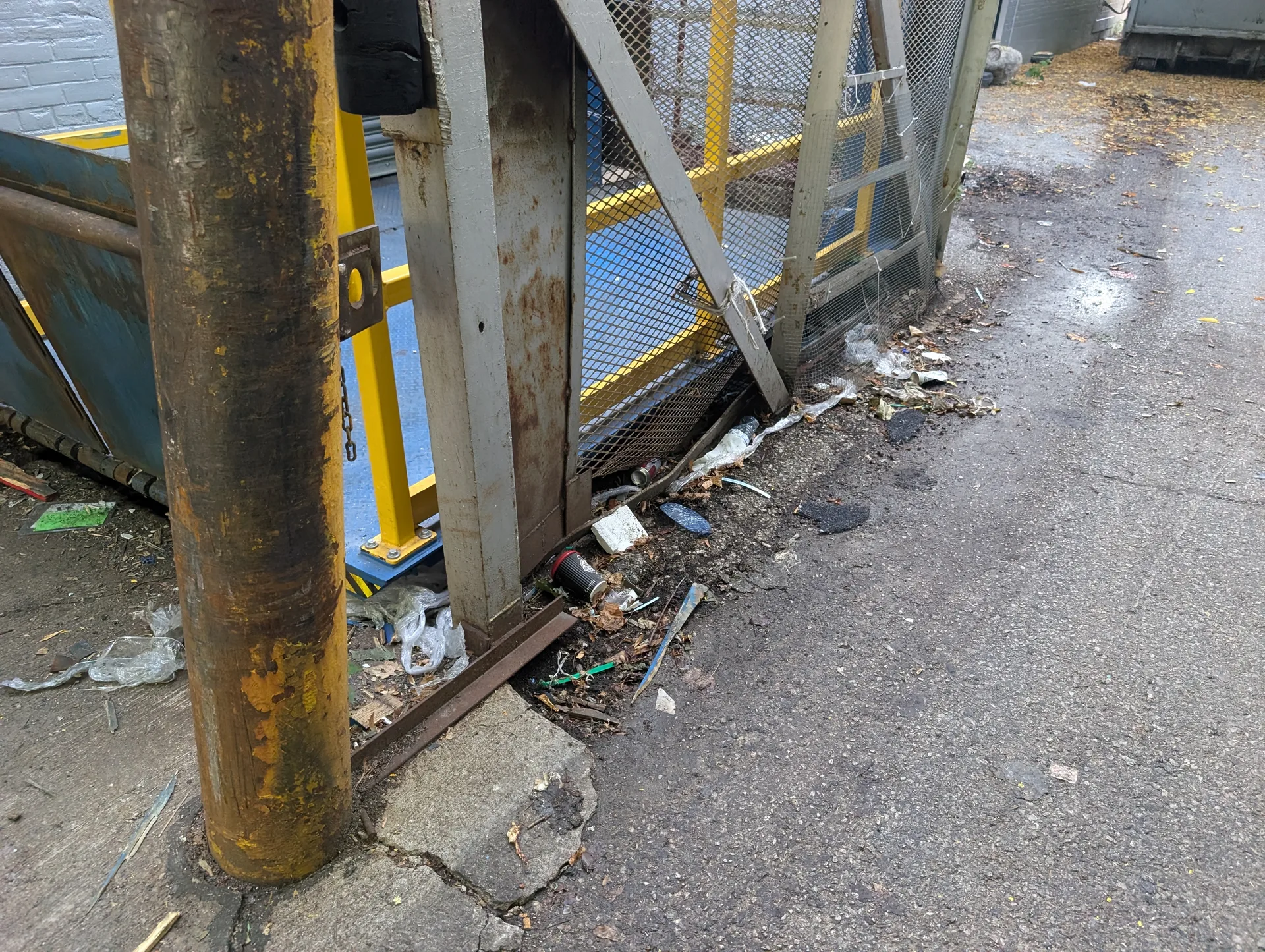 Accumulated litter and industrial debris near site entrance prior to ACE property cleanup.