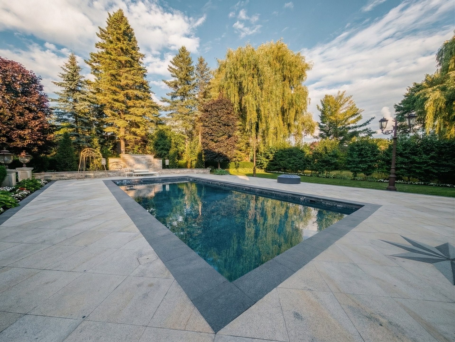 Professional stone pool deck restoration by ACE, removing slippery algae and rust and chlorine stains from a luxury estate patio