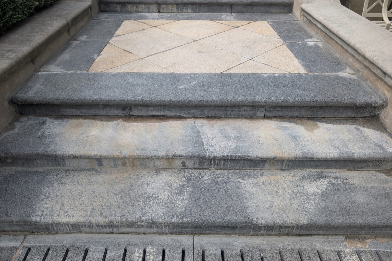 Mineral deposits on black granite steps