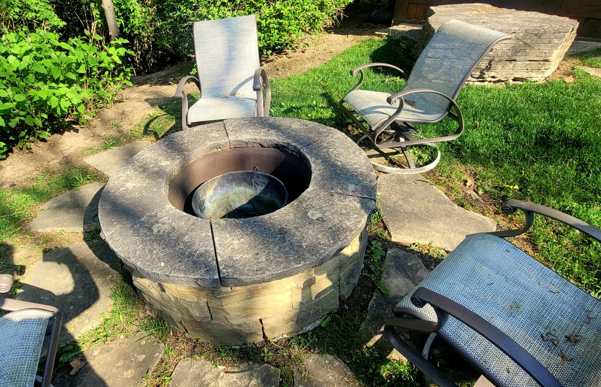Heavy organic growth and carbon buildup on a natural stone estate fireplace in Forest Hill prior to ACE specialized cleaning