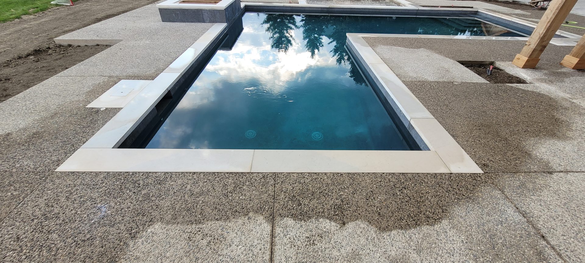 Professional rust stain removal on stone pool copings in Acton after ACE's specialized stone cleaning process