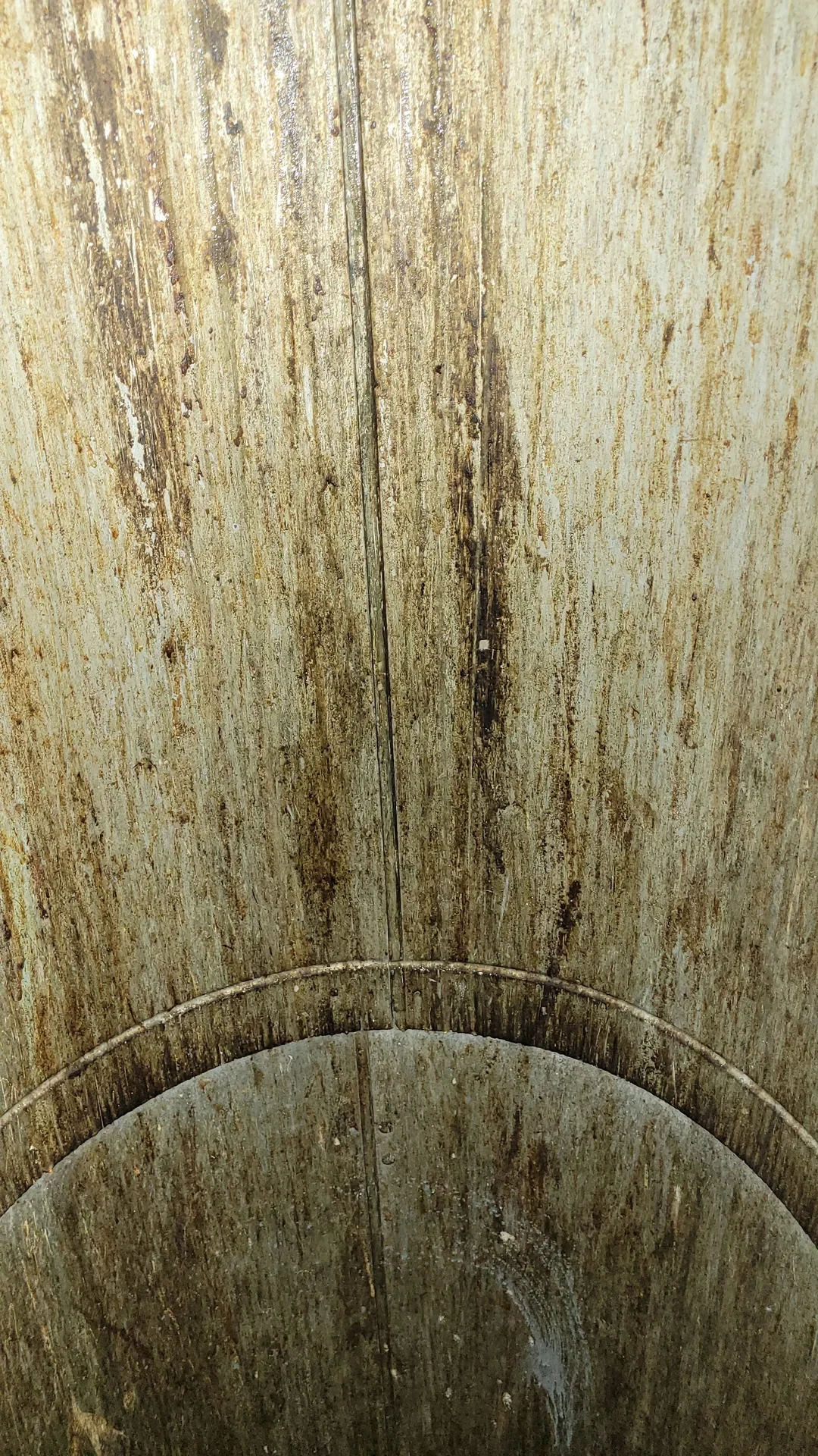 Ace Power Washing: Before photo of heavy organic buildup and grease inside a residential garbage chute