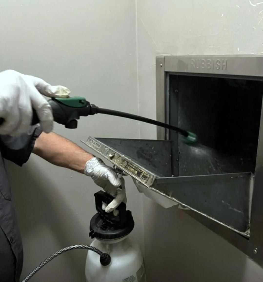 Garbage chute intake pressure washing and sanitizing service