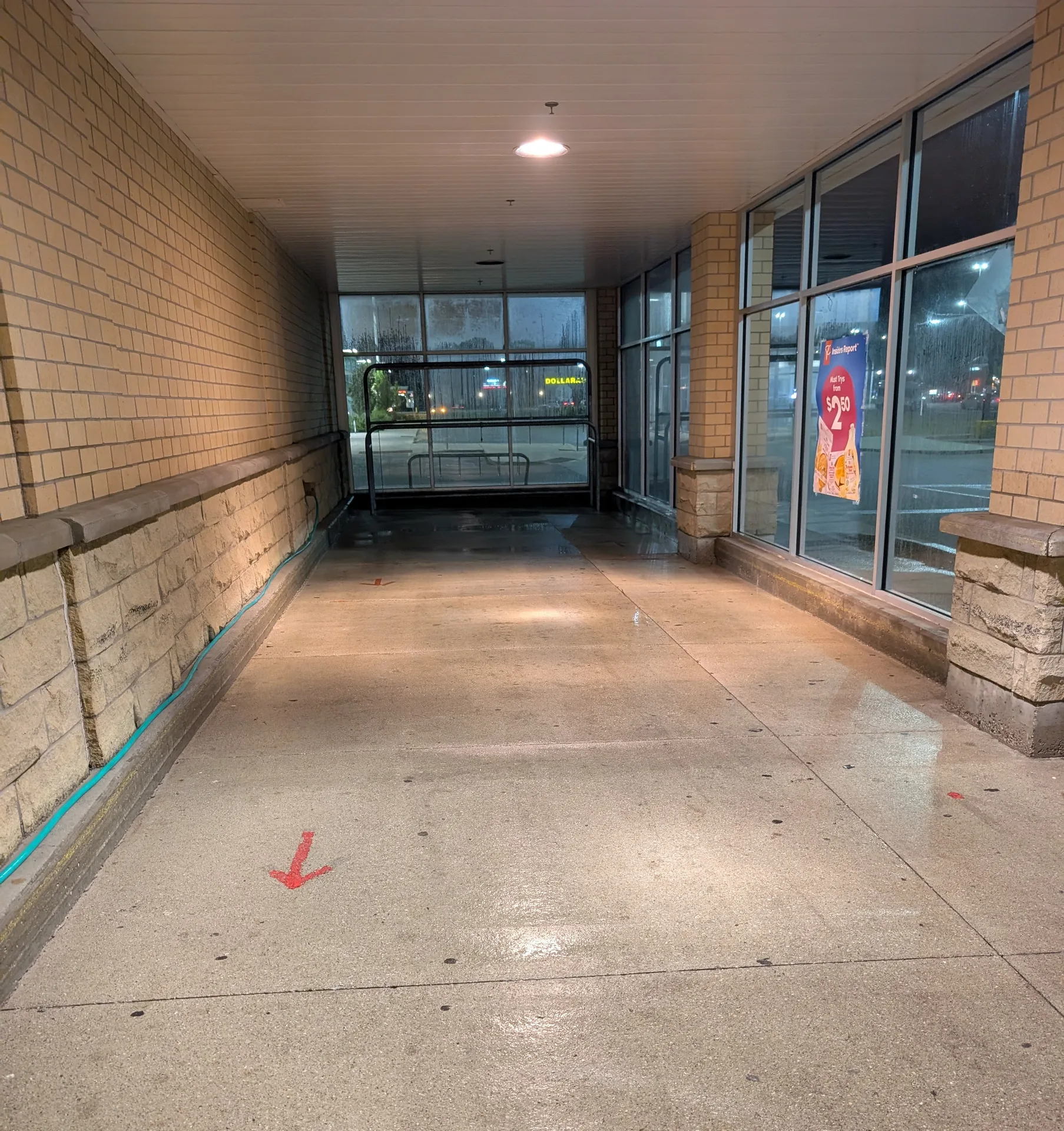Sanitized retail entryway with clean concrete and brickwork, ready for new commercial tenants