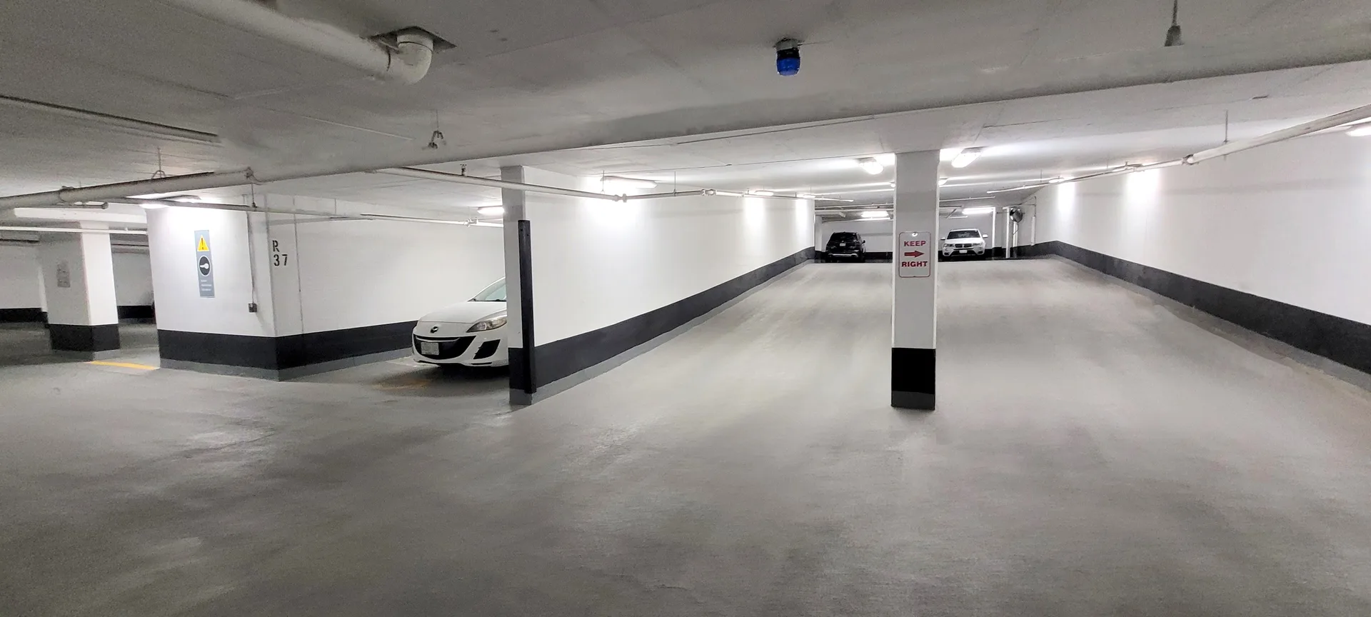 Professional underground garage ramp and floor cleaning by Ace Power Washing for commercial facilities