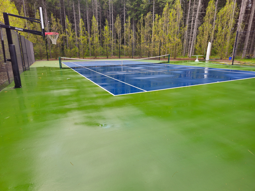 Final pressure washing passes on GTA estate tennis court — completing full surface and surround clean